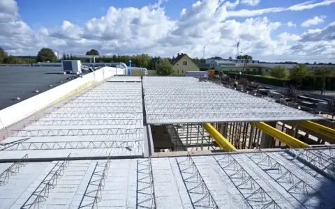 Budowa stropu z prefabrykatów, który jest rozwiązaniem, gdzie jaki strop najtańszy? Widok z góry na konstrukcję.